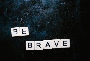 Be brave spelt out using Scrabble letters flatlay